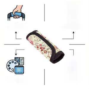 Floral fabric luggage handle cover with pink flower pattern and black piping details