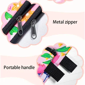 Detailed view of metal zipper and portable fabric handles on mini floral coin pouch