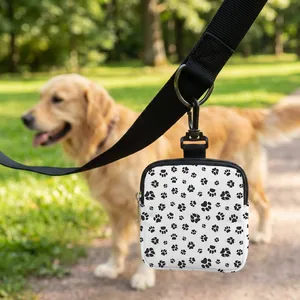 Detail of dog treat pouch with paw prints featuring metal zipper and swivel clip