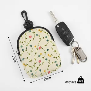 Floral pet snack bag with swivel hook and side zipper shown with car keys for scale