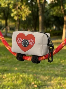 Detail of dog poop bag dispenser with red heart pattern and rubber outlet on leash