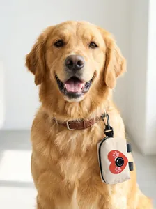 Close-up of a dog waste bag dispenser with heart logo clipped to a golden retriever collar