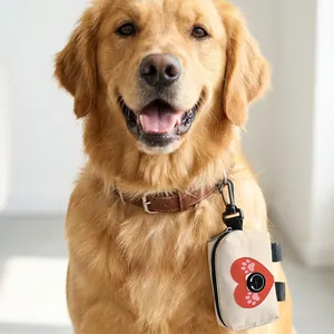 Portable beige dog poop bag dispenser with heart and paw print on Golden Retriever