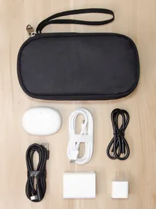 Flat lay of digital accessories organizer bag with power adapters and USB cables