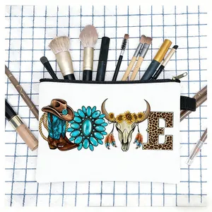 Western style canvas pouch with cow skull and sunflower print used as a makeup organizer bag