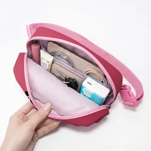 Pink nylon crossbody waist bag with spacious compartments and adjustable strap for sports