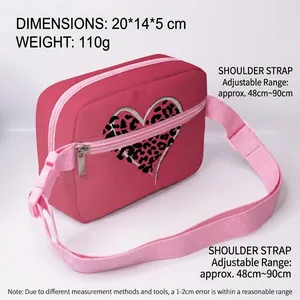 Pink canvas crossbody bag with leopard print heart pattern and adjustable strap