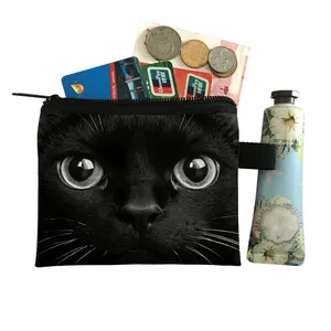 Mini cat pattern coin purse with zipper closure and black lanyard strap shown with cards