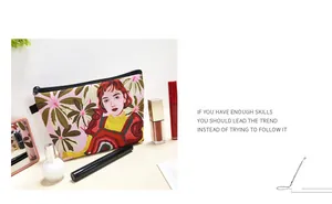Close-up of sloths and floral print makeup bag with smooth metal zipper on wooden table
