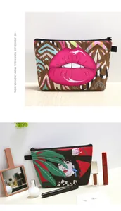 Detail of canvas makeup bags with leopard lip and tropical leaf prints on a desk