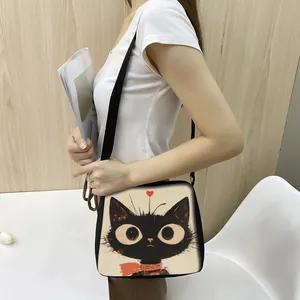 Detailed close-up of a cartoon cat tote bag with an adjustable black shoulder strap