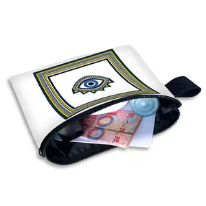 Mini canvas evil eye coin purse with zipper and black strap showing interior capacity