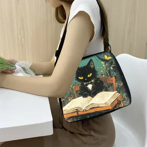 Artistic cat illustration tote bag with adjustable strap worn by model in a cozy setting