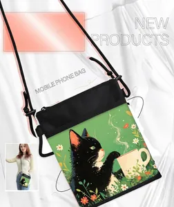 Detail of black canvas cat phone bag with adjustable strap and cute coffee cat illustration