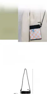 Detailed view of checkered nylon crossbody bag with adjustable strap and bear pattern