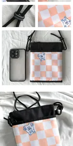 Detailed view of cat-themed crossbody phone bag with pink checkerboard and bear print