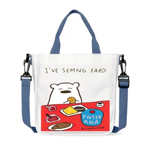 Cartoon bear canvas crossbody bag with blue handles and adjustable shoulder strap