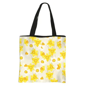Floral print large capacity tote bag with yellow daffodil patterns and black handles