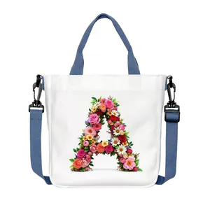 White canvas tote bag with floral letter A print and adjustable blue shoulder strap