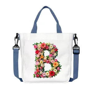 Canvas tote bag with floral letter B print and blue adjustable straps in white