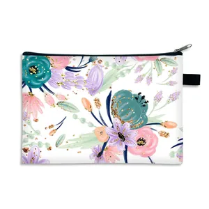 Portable floral makeup bag with blue and pink flower patterns and gold glitter accents