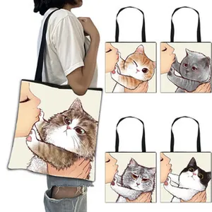 Detail view of large canvas tote bag showing cat print patterns and shoulder straps