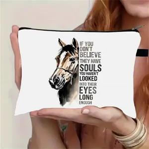 Detail of white canvas cosmetic bag with watercolor horse print and wristlet strap