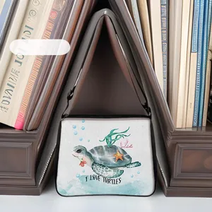 Detailed close-up of turtle print canvas tote with I LOVE TURTLES text on a bookshelf