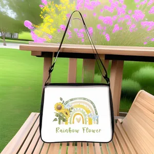 Detail of sunflower rainbow crossbody bag with adjustable strap on a park bench