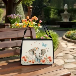 Detailed view of an elephant print crossbody bag on a wooden garden bench outdoors
