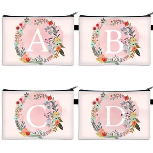 Detail view of pink floral makeup bags featuring A, B, C, D alphabet letters with zipper closure