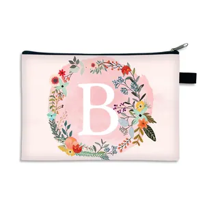 Pink canvas makeup bag featuring letter B with floral wreath and black zipper closure