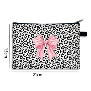 Leopard print makeup bag with pink bow detail showing dimensions 21cm by 15cm