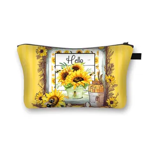 Sunflower pattern dumpling makeup bag with Hello print and black zipper on white background