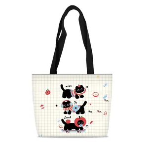 Detail of grid pattern canvas tote bag featuring cute cartoon cats and black straps