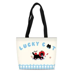 Close-up of cute lucky cat canvas tote bag with blue gingham base and black handle