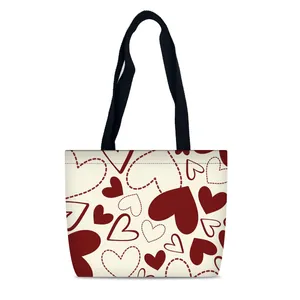 Borsa tote in tela color crema con stampe a cuore rosse e manici neri a contrasto