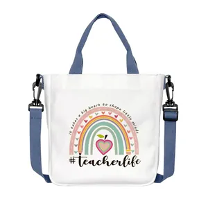 White canvas tote bag with teacher rainbow print and navy blue detachable straps