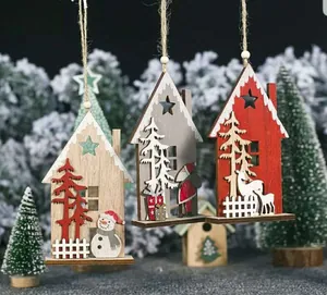 Close-up of wooden Christmas house ornaments with Santa and reindeer laser-cut details