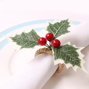 Christmas napkin ring with red berries and green holly leaves on white woven band