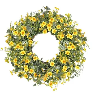 Spring daisy and eucalyptus wreath with yellow flowers on a natural rattan base