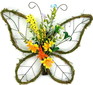 Detail of a handmade rattan butterfly wreath with yellow silk flowers and green foliage