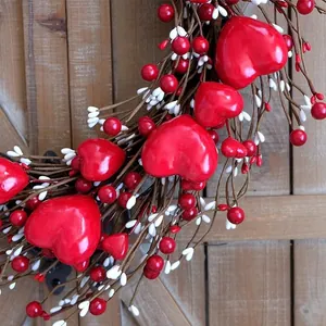 Romantic red and white heart wreath with glossy berries on a rustic wooden background