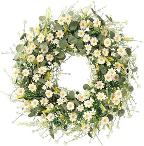 Detailed close-up of white daisies and green eucalyptus leaves on a spring floral wreath