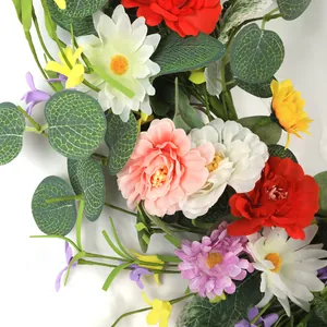 Colorful artificial daisy and wildflower wreath with green eucalyptus leaves for spring decor
