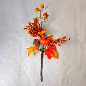 Detailed view of artificial pumpkin with maple leaves, pine cones and berries for autumn