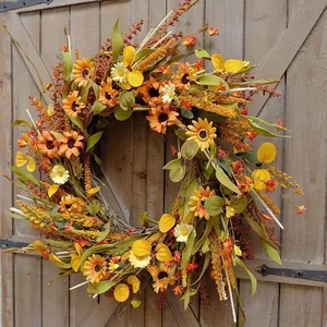 Close-up of autumn door wreath with orange sunflowers and daisies on rustic barn door