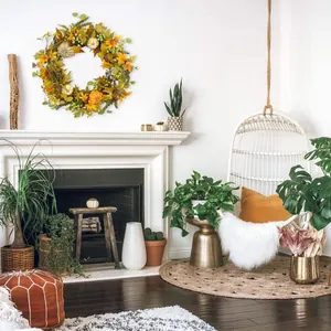 Fall wreath with orange maple leaves, pumpkins and green berries for autumn home wall decor
