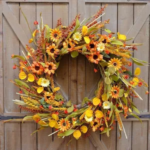 Close-up of fall harvest wreath with sunflowers and daisies on a rustic wooden door