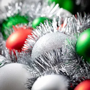 Assorted Christmas ball ornaments in red green and silver with tinsel for festive decor